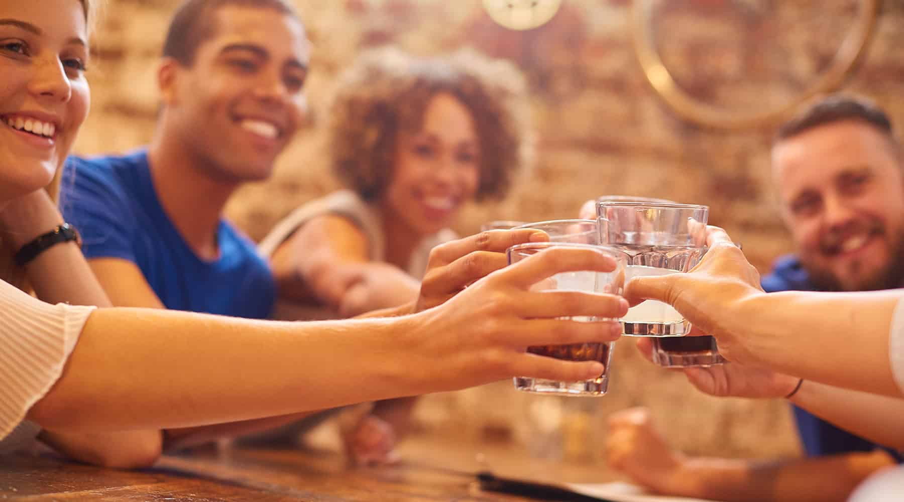 A group of Renaissance Square residents make a toast with drinks in Concorde, CA