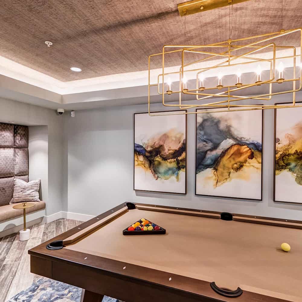Modern billiard table in an art-decorated lounge at Renaissance Square apartments.