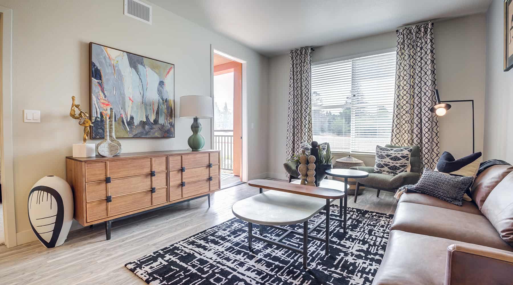 Spacious living area with a door to the balcony.