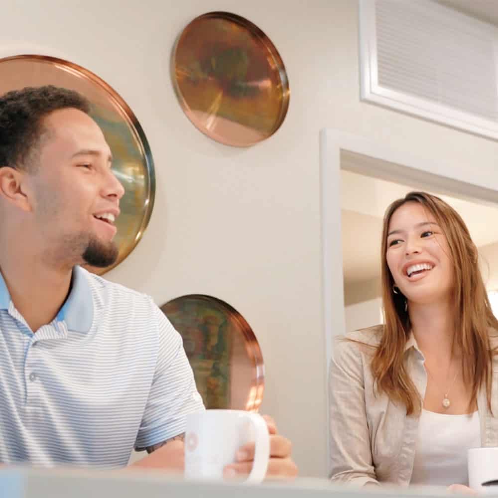 A couple having a conversation in the common area of their apartment at Concorde, California's Renaissance Square