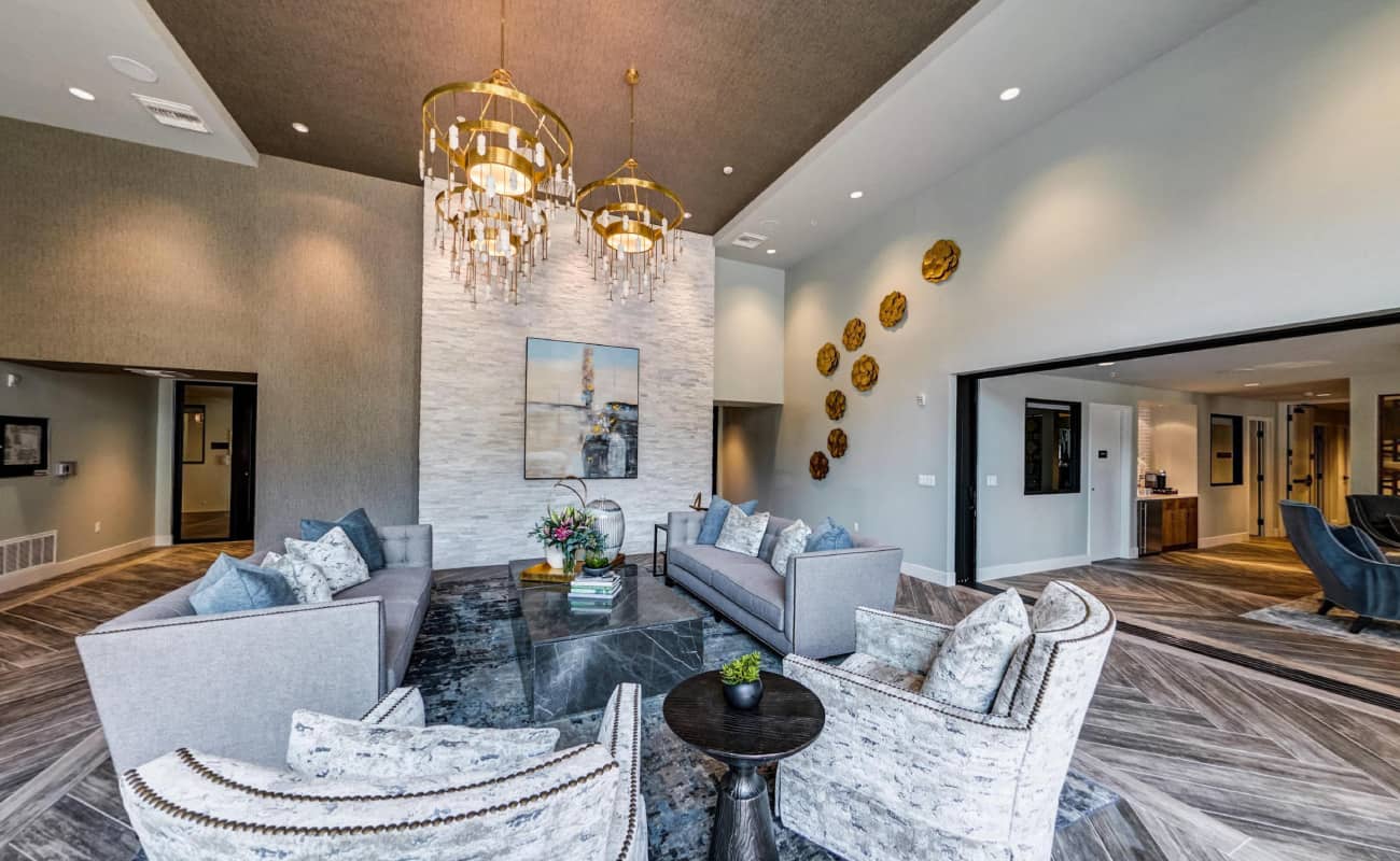 Lobby of Renaissance Square with seating area of 2 couches under a chandelier