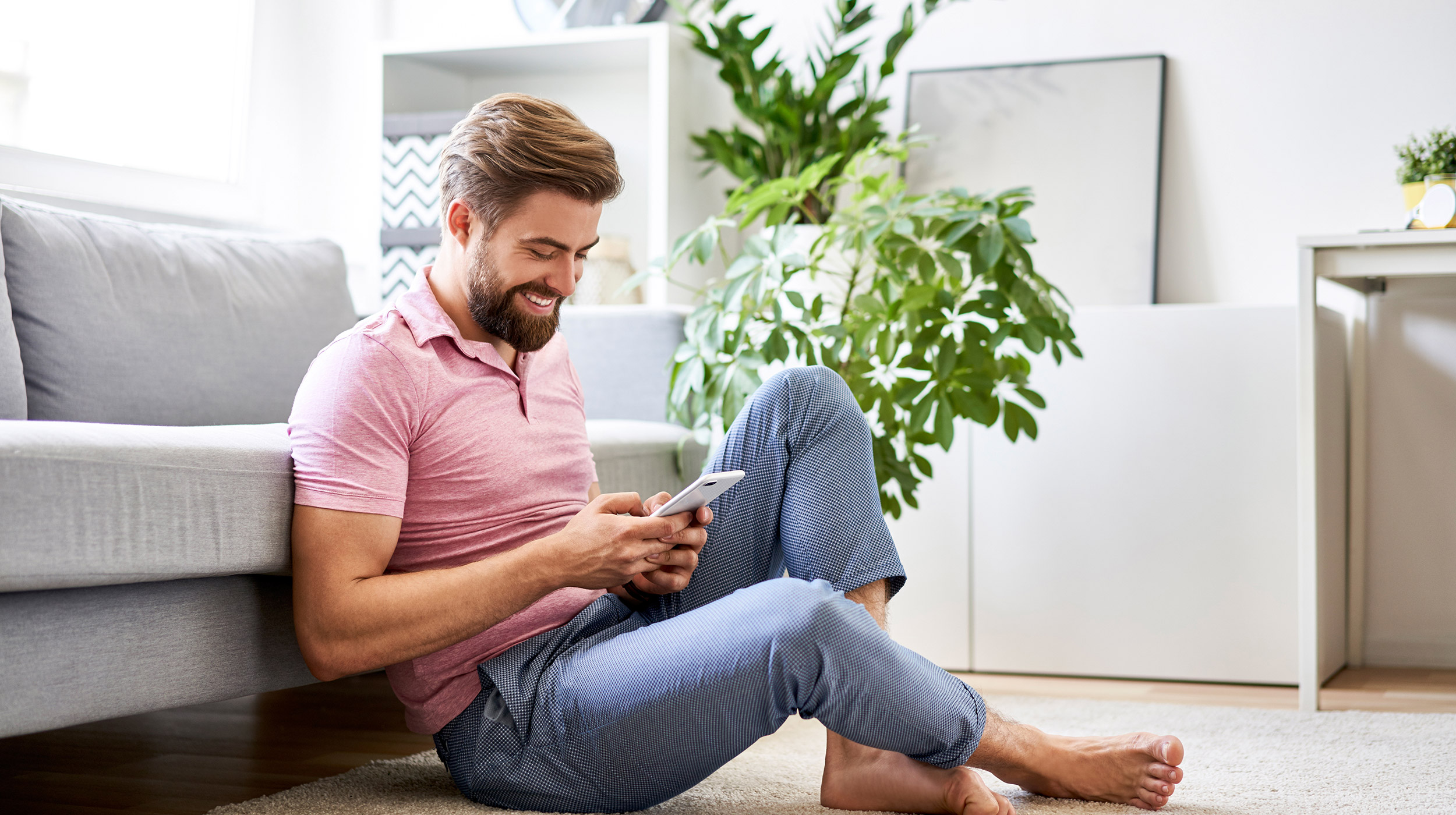 Man enjoying iPad in living room